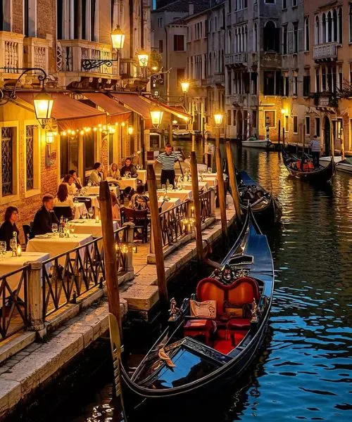 Romantic gondola ride in Venice, Italy with candlelit dinners, part of Europe tour packages.