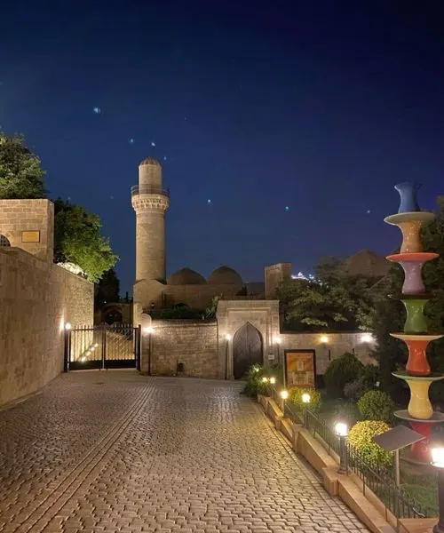 Evening view of Baku Old City and mosque – discover historic charm with Baku Tour Packages from Lucknow.