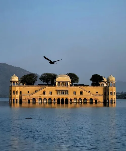 Jal Mahal palace reflected in Man Sagar Lake, Jaipur, highlighting serene royal architecture and a popular sightseeing spot in a Jaipur tour package.